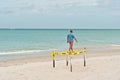 Loggerhead turtle nest, corded off by yellow tape, at a tropical sandy beach