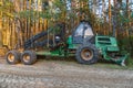 Logging equipment in the forest, loading logs for transportation. Harvesting and storage of wood in the forest. Transportation of Royalty Free Stock Photo