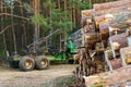 Logging equipment in the forest, loading logs for transportation. Harvesting and storage of wood in the forest. Transportation of Royalty Free Stock Photo