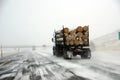 Logging truck on icy road Royalty Free Stock Photo