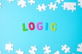 LOGIC text with white puzzle jigsaw pieces on blue background. Concepts of logical thinking, Conundrum, solutions, rational,