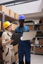 Logistic department warehouse workers monitoring freight distribution on laptop Royalty Free Stock Photo