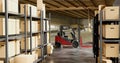 Logistic and merchandise warehouse with parcel racks for shipment and forklift machine. Concept of trade and