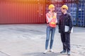 Logistic worker man and woman working team with radio control loading containers at port cargo to trucks for export and import Royalty Free Stock Photo