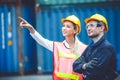 Logistic worker man and woman working team with radio control loading containers at port cargo to trucks for export and import Royalty Free Stock Photo