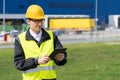 Logistician with digital tablet on a background of logistic center