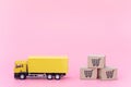 Logistics, and delivery service - Cargo truck and paper cartons or parcel with a shopping cart logo on Pink background. Shopping Royalty Free Stock Photo