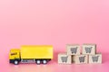 Logistics, and delivery service - Cargo truck and paper cartons or parcel with a shopping cart logo on Pink background. Shopping Royalty Free Stock Photo