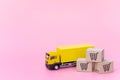 Logistics, and delivery service - Cargo truck and paper cartons or parcel with a shopping cart logo on Pink background. Shopping Royalty Free Stock Photo