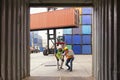 Logistics engineer control at the port. Foreman and staff are opening containers to check stock Royalty Free Stock Photo