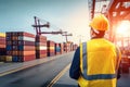 Logistics engineer control at the port, loading containers for trucks export and importing logistic