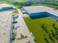 Logistics park with warehouse. Semi-trailers trucks standing on car parking and waiting for loading and unloading goods at ramps. Royalty Free Stock Photo