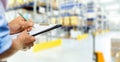 logistics service man writing documents on clipboard in warehouse