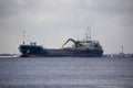 Logistics and transportation Cargo ship with ports crane bridge coming in port Royalty Free Stock Photo