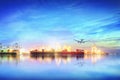 Logistics and transportation of international container cargo ship and cargo plane with ports crane bridge in harbor at sunset