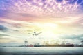 Logistics and transportation of international container cargo ship and cargo plane with ports crane bridge in harbor at sunset Royalty Free Stock Photo