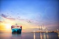 Logistics and transportation of International Container Cargo ship and cargo plane in the ocean at twilight sky Royalty Free Stock Photo
