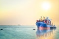 Logistics and transportation of International Container Cargo ship with tugboat in the ocean at sunset sky, Freight Transportation