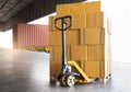 Cargo freight truck, Delivery. Hand pallet jack with stack cardboard boxes on pallet waiting to load into cargo container. Royalty Free Stock Photo