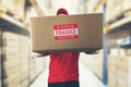 Logistics warehouse worker holding package with fragile items Royalty Free Stock Photo