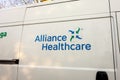 The logo of the Alliance Healthcare company on a white van which transport drugs and medical equipment