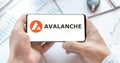 Logo of Avalanche coin in tablet. Cryptocurrency AVAX token. Trading blockchain platform to buy,sell on decentralized exchange DEX