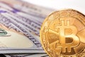 Bitcoin and hundreds dollars banknotes
