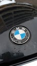 Logo of the BMW on the hood of the car wet from the rain Royalty Free Stock Photo