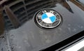 Logo of the BMW on the hood of the car wet from the rain Royalty Free Stock Photo