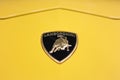 Logo of the car in yellow Lamborghini Urus. Lamborghini logo on a yellow car body. Royalty Free Stock Photo