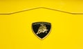 Logo of the car in yellow Lamborghini Urus. Lamborghini logo on a yellow car body. Royalty Free Stock Photo