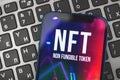Logo close-up, non-fungible token NFT is a type of cryptorurrency which represents something unique