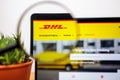 Logo of DHL on a laptop desktop under a magnifying glass Royalty Free Stock Photo