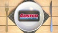 Logo of COSTCO on the display of smartphone on the plate. Editorial food or groceries delivery concept, 3D rendering