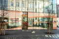 The logo of Drogeriemarkt DM drugstore shop above an entrance with a sun reflection. The store is located at 28. rijna street in