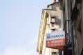 Logo of Foncia Immobilier in front of a flat for sale by the real estate broker in Bordeaux.