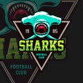The logo of the football team with a shark