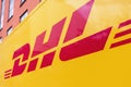 Logo of the German delivery service DHL on a yellow delivery van