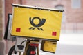 Logo of german mail - Deutsche Post - on yellow background on bicycle