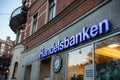 The logo of the Handelsbanken bank on a street in Stockholm, Sweden during the early twilight