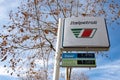 The logo of the Italpetroli gas station on a small white banner with the prices for diesel and senza PB petrol fuel in perspective