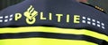 Logo of the police in the Netherlands named Politie on the back of a officer.