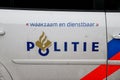 Logo of the police in the Netherlands named Politie with the blue and red striping on a police car.