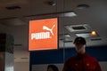 The logo of the Puma clothing brand in a dark shop with a figurine