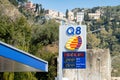 The logo of Q8 gas station on a banner with prices of gasoline and diesel fuel displayed