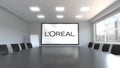 L'Oreal logo on the screen in a meeting room. Editorial 3D rendering'