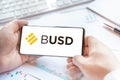 Logo of stablecoin BUSD,Binance USD in tablet. Cryptocurrency stable coin, token. Trading blockchain platform to buy,sell on