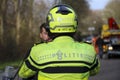 Logo and striping of the Dutch police (politie) on helmet and jacket of motor officer