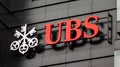 The logo of a Swiss bank UBS on a black wall of building