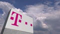Logo of T TELEKOM on a stand against cloudy sky, editorial animation
